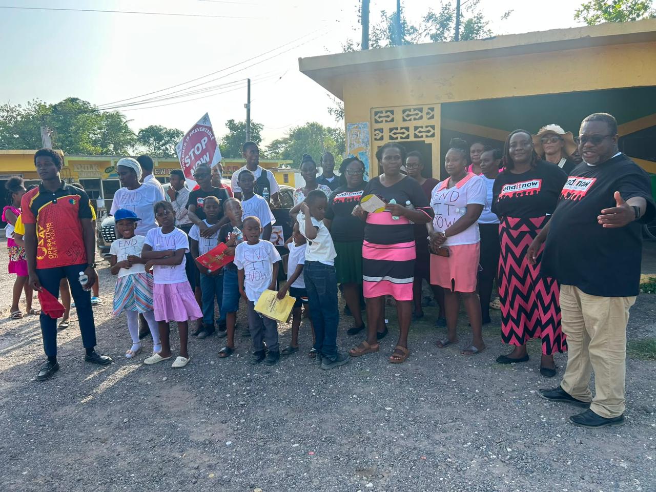 Members of the Hayes SDA church gather at a bus stop in an area of the community, encouraging persons to help bring an end to violence. :: Photo credit: Contributed